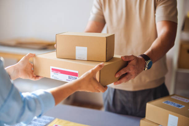 istock Person Receiving Delivery Boxes in a Home Setting 2166223645