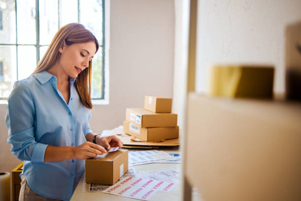 istock Woman Preparing Packages for Delivery in Home Office 2166223663