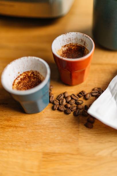 istock Two espresso cups with coffee beans on a wooden table 2166226194