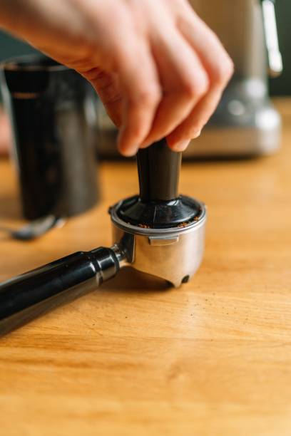 istock A barista preparing espresso with a portafilter on a coffee machine 2166226252
