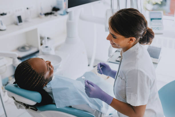 istock Dentist Checking Patient's Teeth in Modern Clinic 2166226993