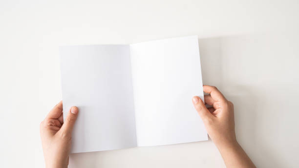 istock Holding a blank page in hand 2166227650