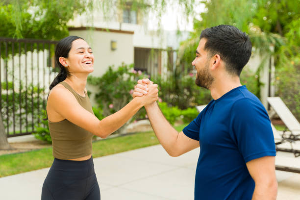 istock Cheerful athletic couple is shaking hands and making a deal while taking a break from exercising together outdoors 2166227977