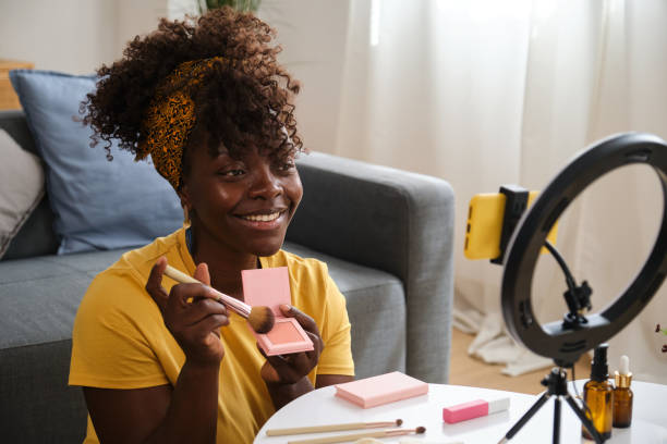 istock Beauty influencer applying makeup while recording video with ring light 2166228317
