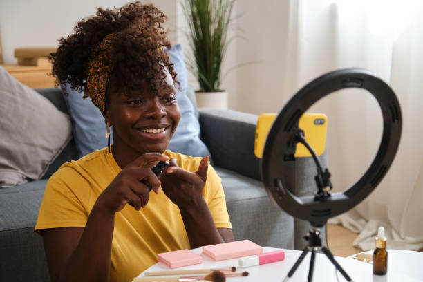 istock Beauty influencer applying makeup while recording video with smartphone 2166229037