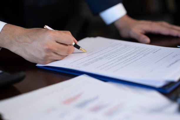 istock Close-up Young businessman hand signing contract 2166229297