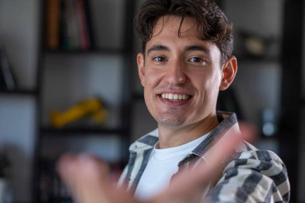 istock Smiling young man extending his hand to the camera 2166229329