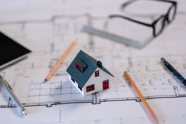 istock Model houses and pencils stand on architectural project papers 2166229513