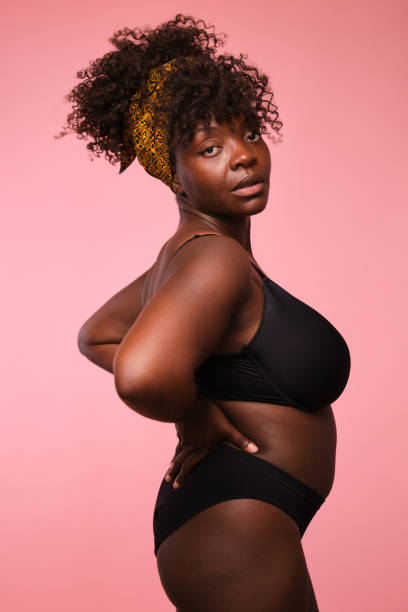 istock Confident black woman is posing on a pink background 2166230948