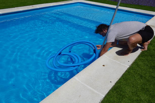 istock man connect pool cleaner pipe to clean summer swimming pool 2166230969