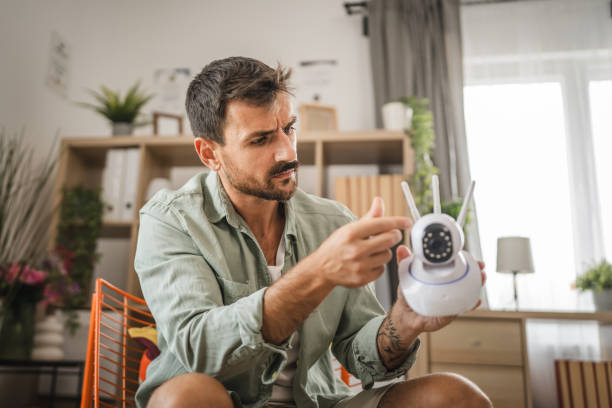 istock Adult man at home connect install cctv security surveillance camera 2166235715