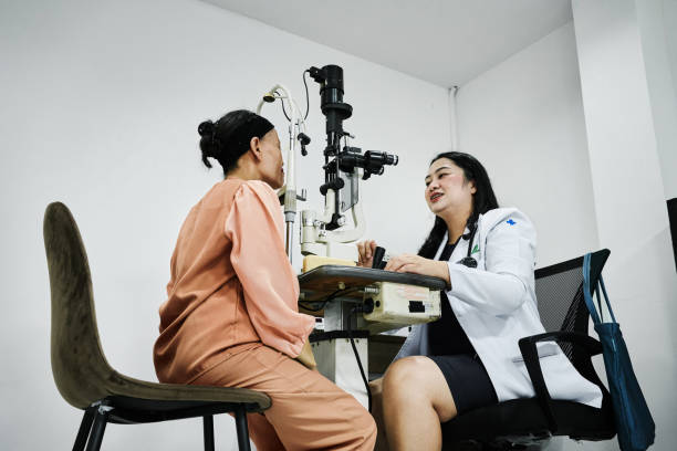istock Doctor checking mature woman patient eyes using retinal scanner in clinic 2166239852