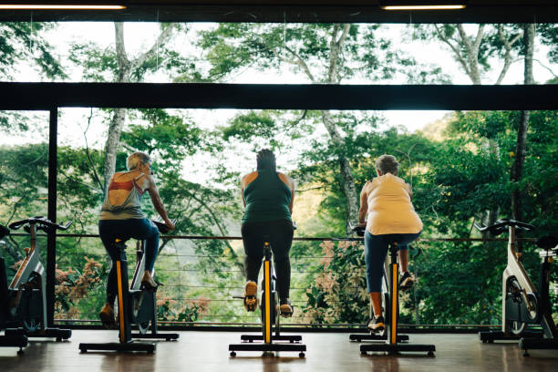 Group of mature women practicing together in a luxury gym of a spa during holidays