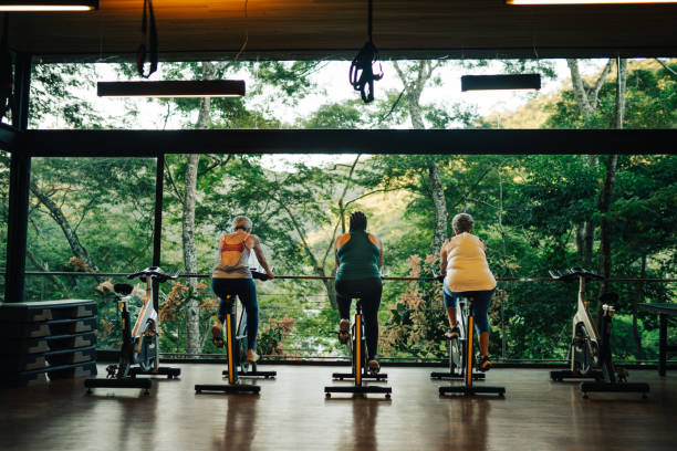 Group of mature women practicing together in a luxury gym of a spa during holidays