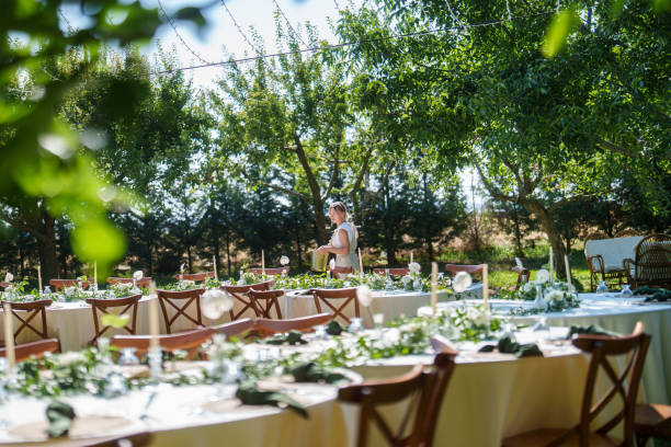 istock Wedding planner woman is working on floral decorations for a wedding event. 2166246203