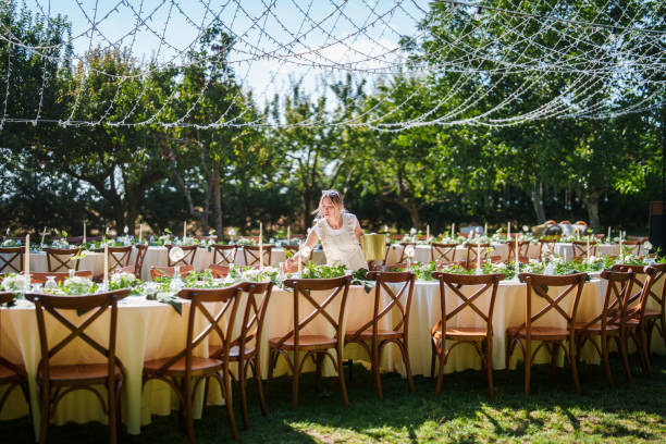 Wedding planner woman is working on floral decorations for a wedding event.