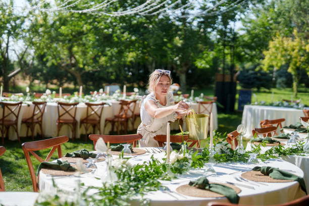 istock Wedding planner woman is working on floral decorations for a wedding event. 2166246363
