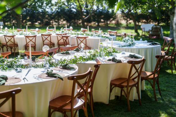 Dining tables decorated with flowers for a rustic wedding reception
