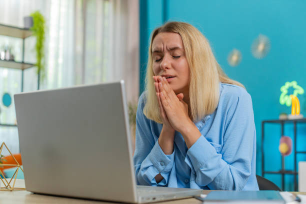 istock Upset woman with hands joined at web camera of laptop compute asking more time for task completion 2166246587