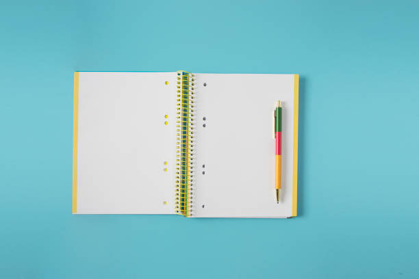 istock Open notepad and color pen on light blue background for back to school, study and education concept 2166246983