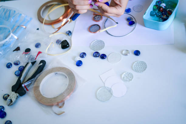 istock Stained glass workshop. Table with pieces of glass and necessary tools. 2166248451