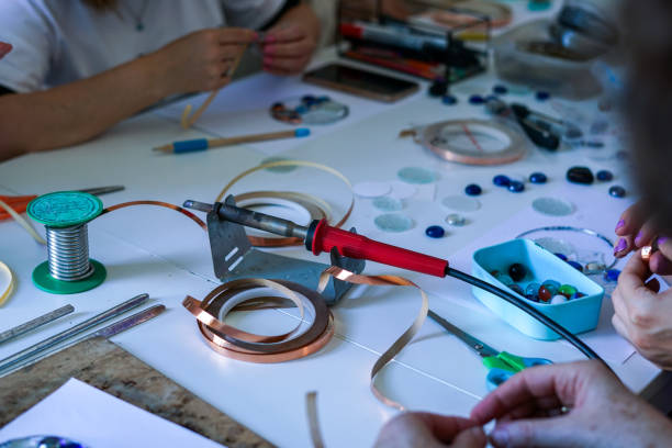 istock Stained glass workshop. Table with pieces of glass and necessary tools. 2166248480