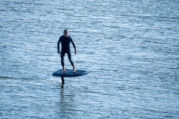 istock Silhouetted man on a hydrofoil surfboard 2166249424