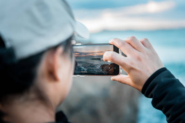 istock Recording the sunset on the phone 2166249749