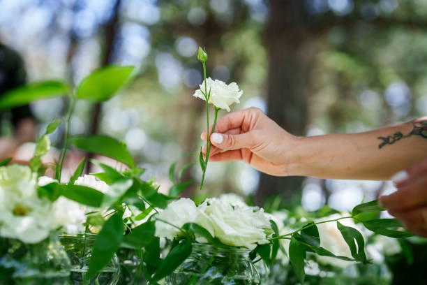Moments of the team working on floral decorations for a wedding event.