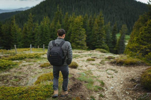 istock Lonely man trekking in the mountain. 2166253429