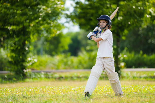 istock Kids playing cricket in summer park 2166254720