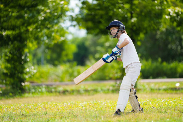 istock Kids playing cricket in summer park 2166254767