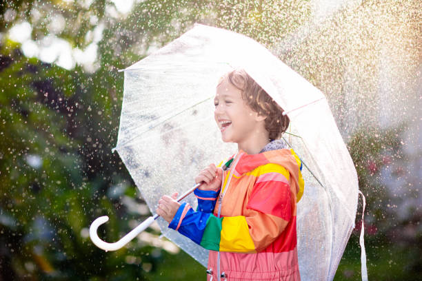 istock Child playing in autumn rain. Kid with umbrella. 2166255191