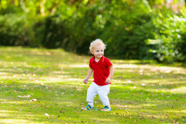 istock Child in fall park. Kid with autumn leaves. 2166255544