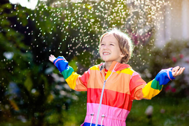 istock Child playing in autumn rain. Kid with umbrella. 2166255778