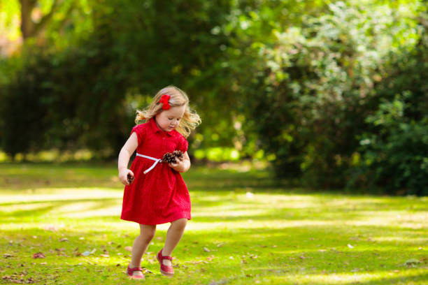 istock Child in fall park. Kid with autumn leaves. 2166255837