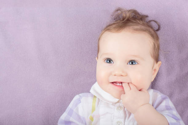 A cute little baby woke up with an infected eye and is happily looking at her mother.