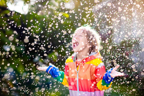 istock Child playing in autumn rain. Kid with umbrella. 2166256428