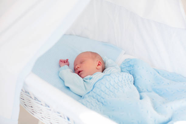 istock Newborn baby boy in white bassinet 2166257340