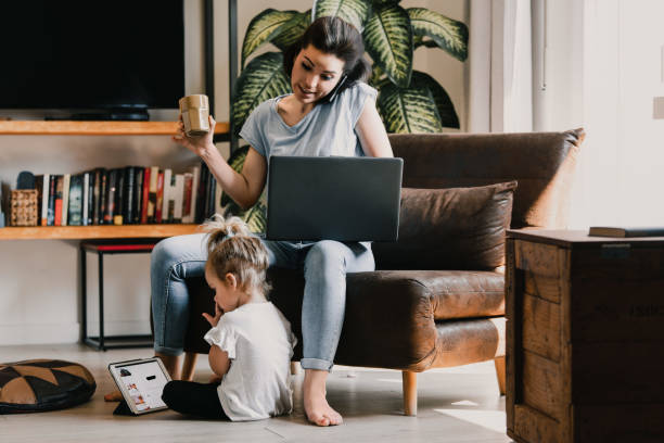 Mother managing work and childcare responsibilities at home