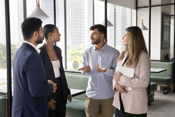 istock Positive young Arab professional man talking to diverse colleagues 2166264889