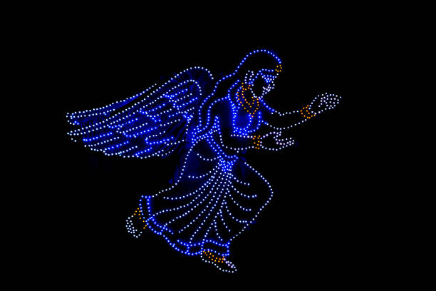 Angel of lights playing the trumpet at the Christmas market in Trento, a historic city in Trentino, northern Italy