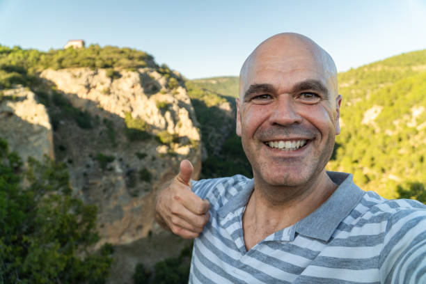 istock Happy man takes a selfie with mountains on background 2166272555