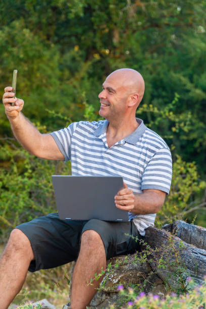 istock Man working in nature with a laptop, digital nomad concept 2166272565
