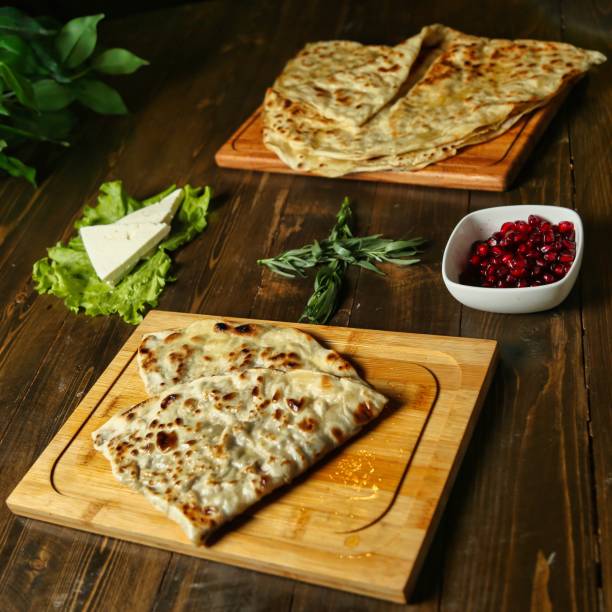 Flatbread on Wooden Cutting Board With Pomegranate Seeds