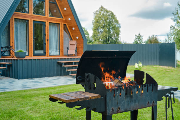 istock Brazier with burning wood on the background of a triangular house 2166278094