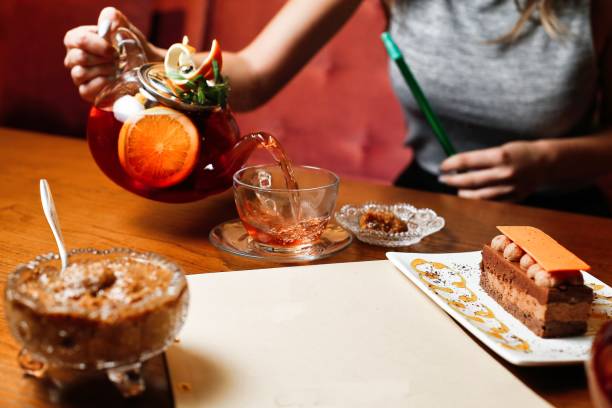 istock Woman Pouring Tea With Orange and Mint 2166278682