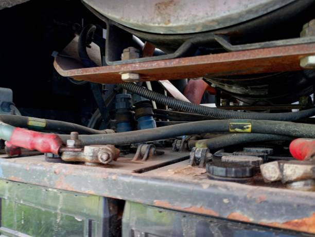 istock Engine compartment with heavy large truck batteries with various wires and assemblies. Background with heavy equipment. Construction and repair of equipment. 2166278809
