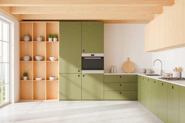 istock Green kitchen interior with cooking cabinet, shelves and panoramic window 2166279719