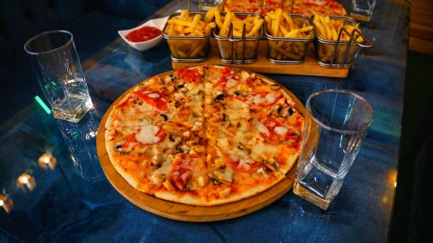 istock Pizza and Fries on a Blue Table 2166279756